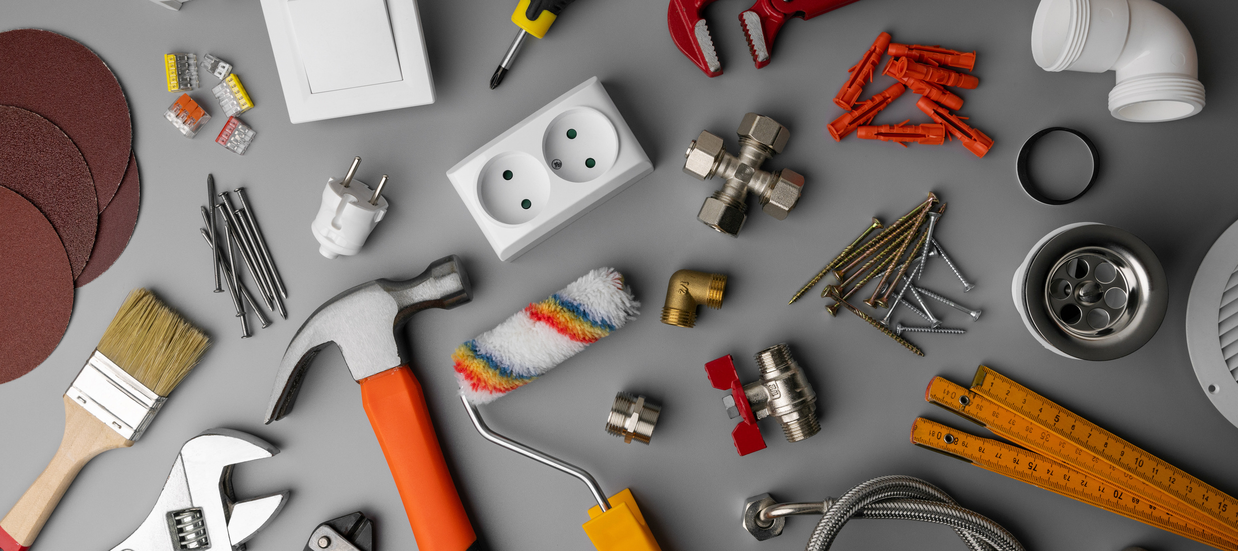 household hardware store tools and items on gray background. home repair. banner
